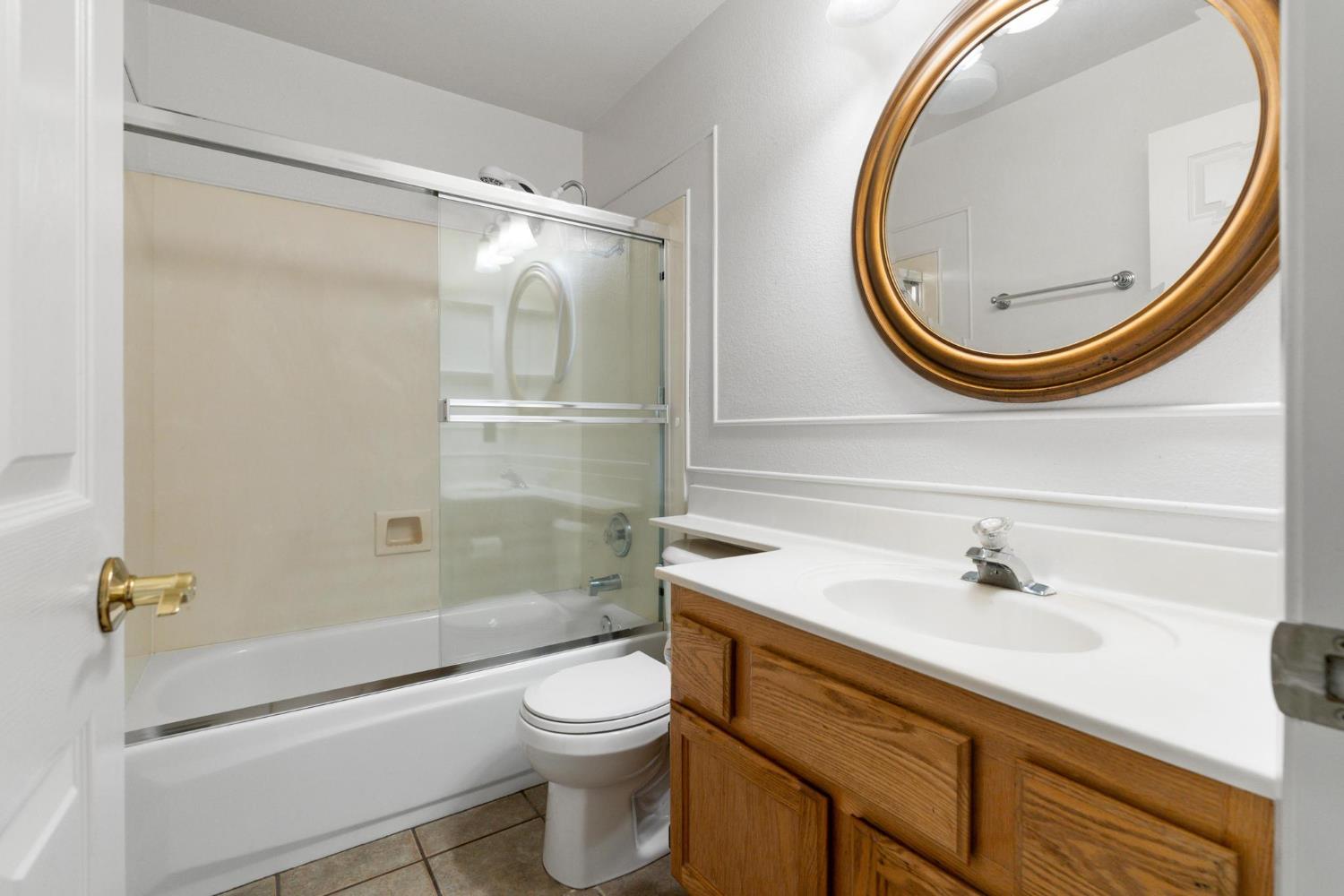 1833 Rail Street Manteca, CA 95337 - Photo 26 of 40 a bathroom with a sink a toilet and a mirror