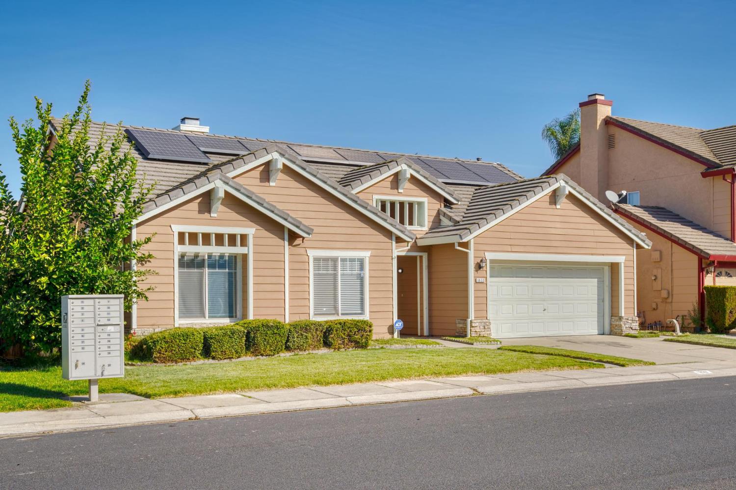 1833 Rail Street Manteca, CA 95337 - Photo 3 of 40 a view of a house with a yard and large tree