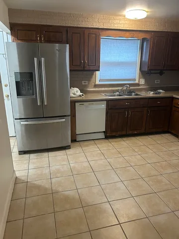 a kitchen with stainless steel appliances granite countertop a stove a sink dishwasher and a refrigerator