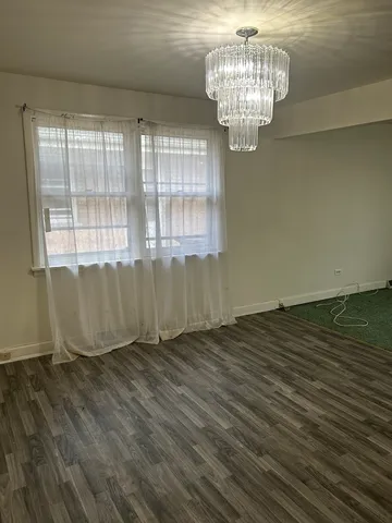 a view of a room with wooden floor and fence