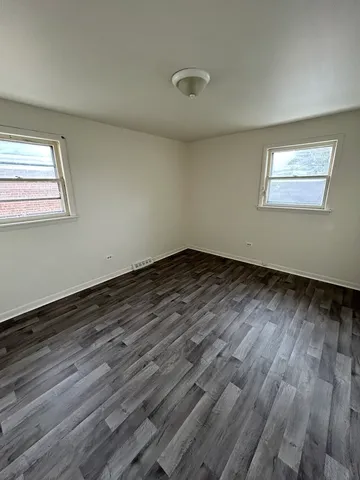 a view of closet with wooden floor