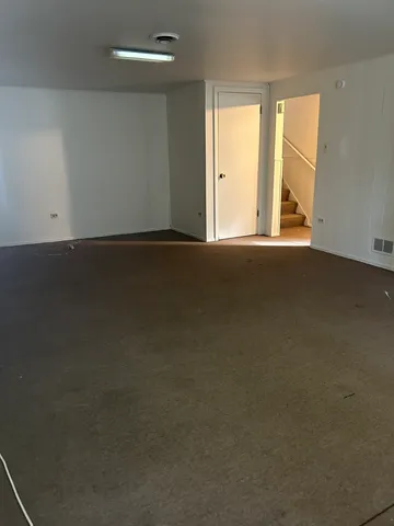 a view of a house with backyard and trees