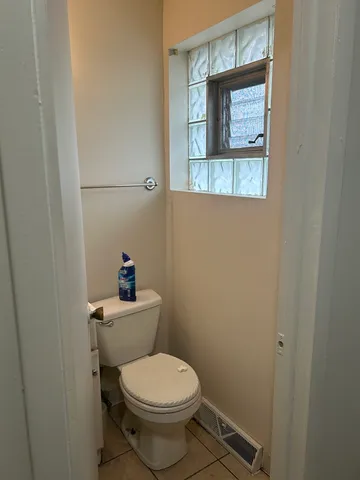 a white toilet sitting next to a bathroom sink