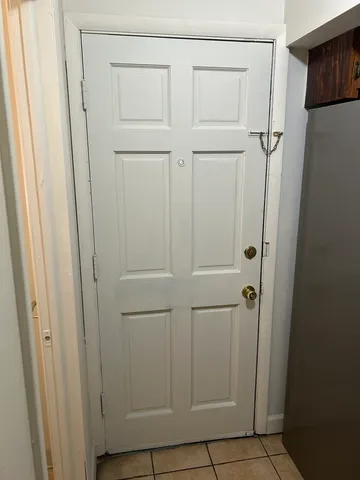 a kitchen with stainless steel appliances kitchen island granite countertop a stove and a refrigerator