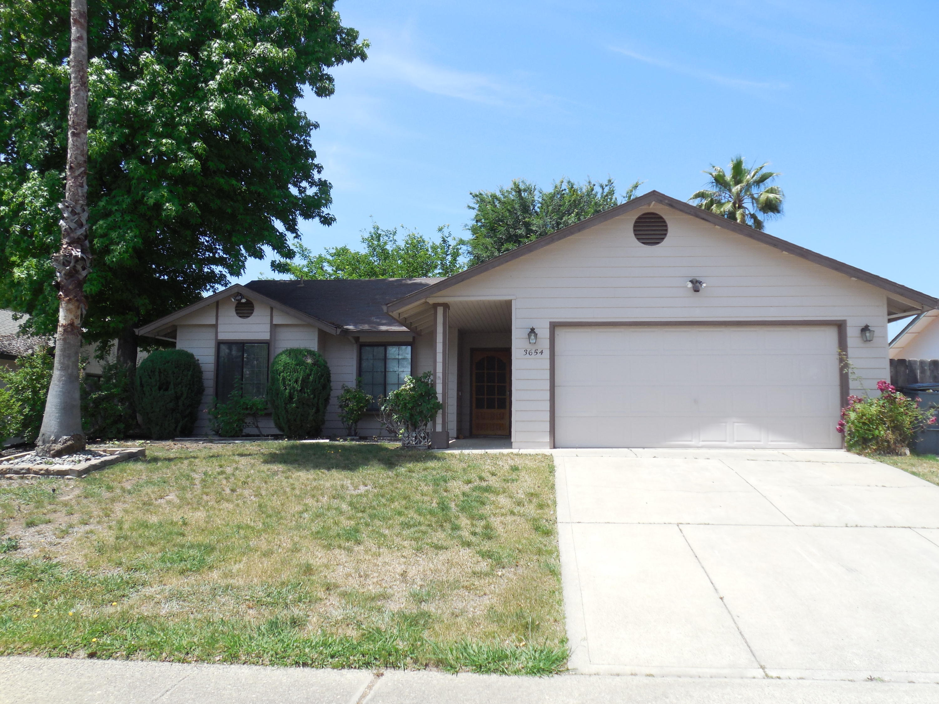3654 Santa Rosa Way Redding, CA 96003 - Photo 1 of 16 a front view of a house with a yard