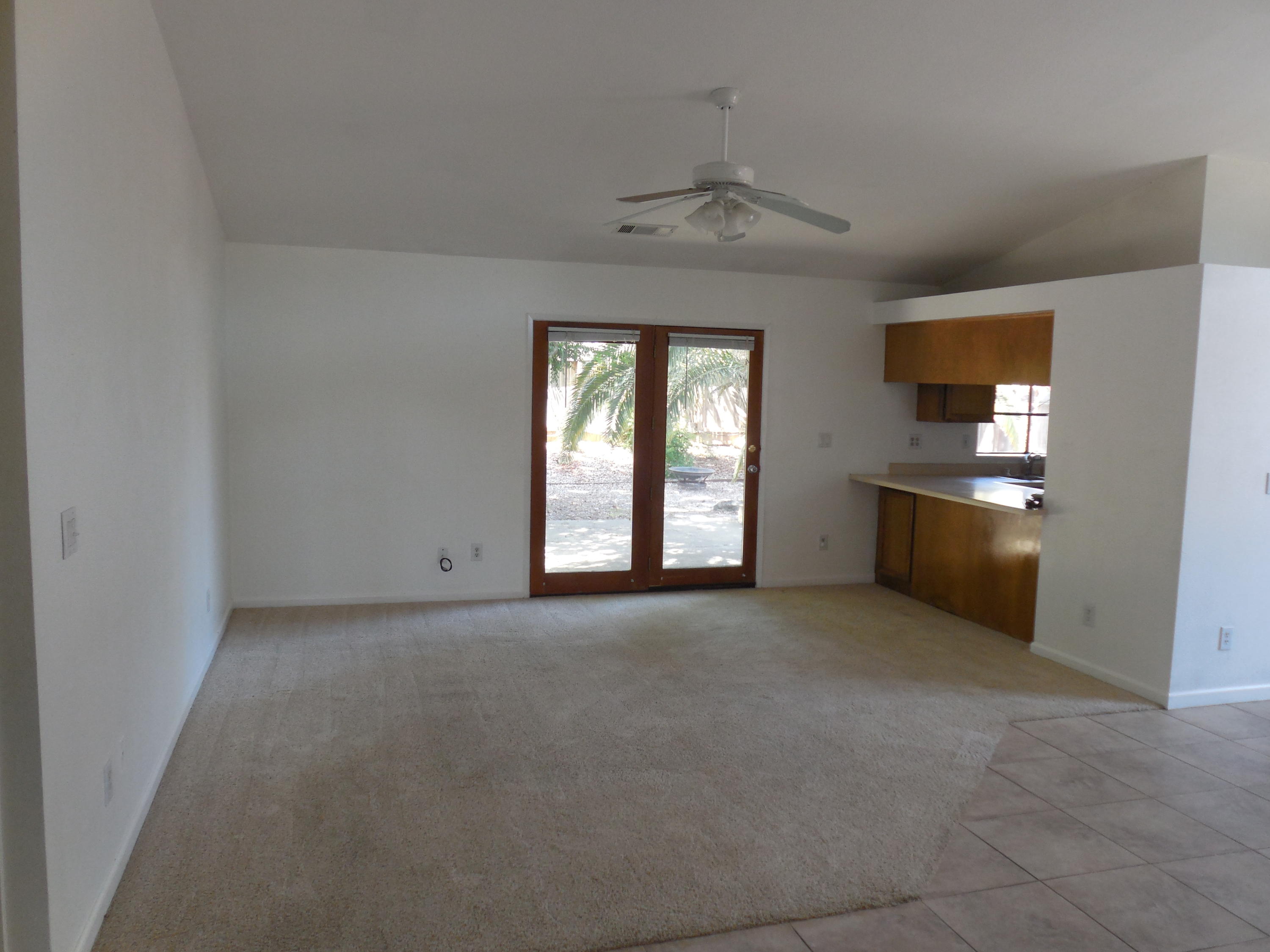 3654 Santa Rosa Way Redding, CA 96003 - Photo 4 of 16 an empty room with windows and chandelier fan