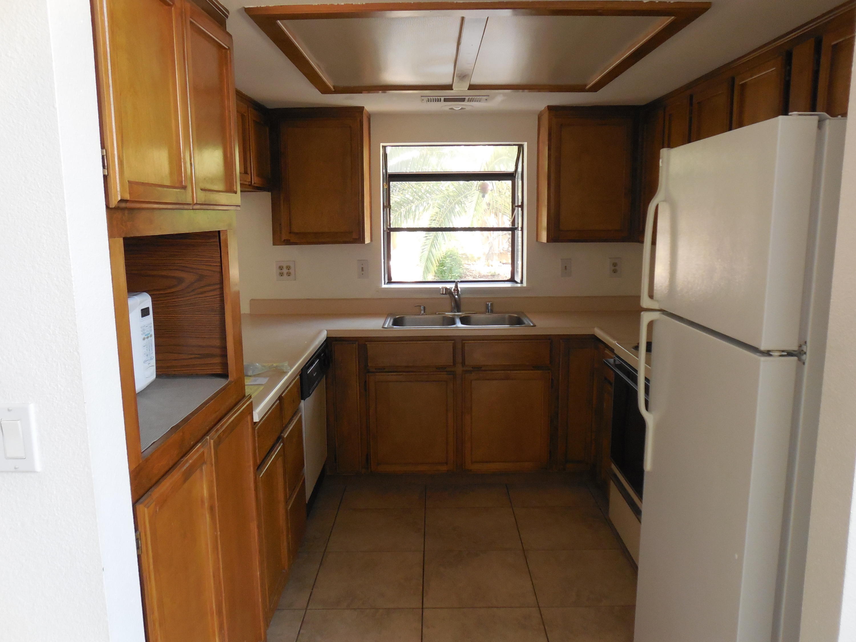 3654 Santa Rosa Way Redding, CA 96003 - Photo 9 of 16 a kitchen with a sink a refrigerator and cabinets