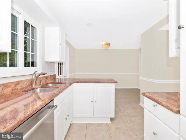 a kitchen with granite countertop a sink and a stove