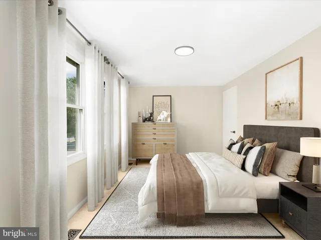 a bedroom with a bed and a painting