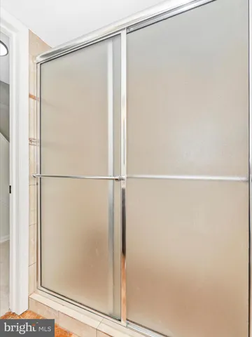 a bathroom with a glass shower door