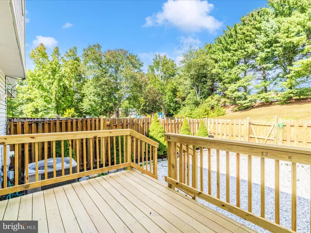 a view of backyard with wooden fence