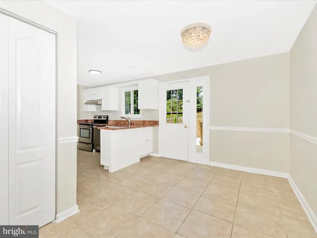 a view of kitchen with refrigerator and window