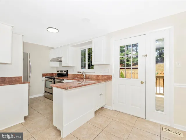 a kitchen with a stove a refrigerator and a sink