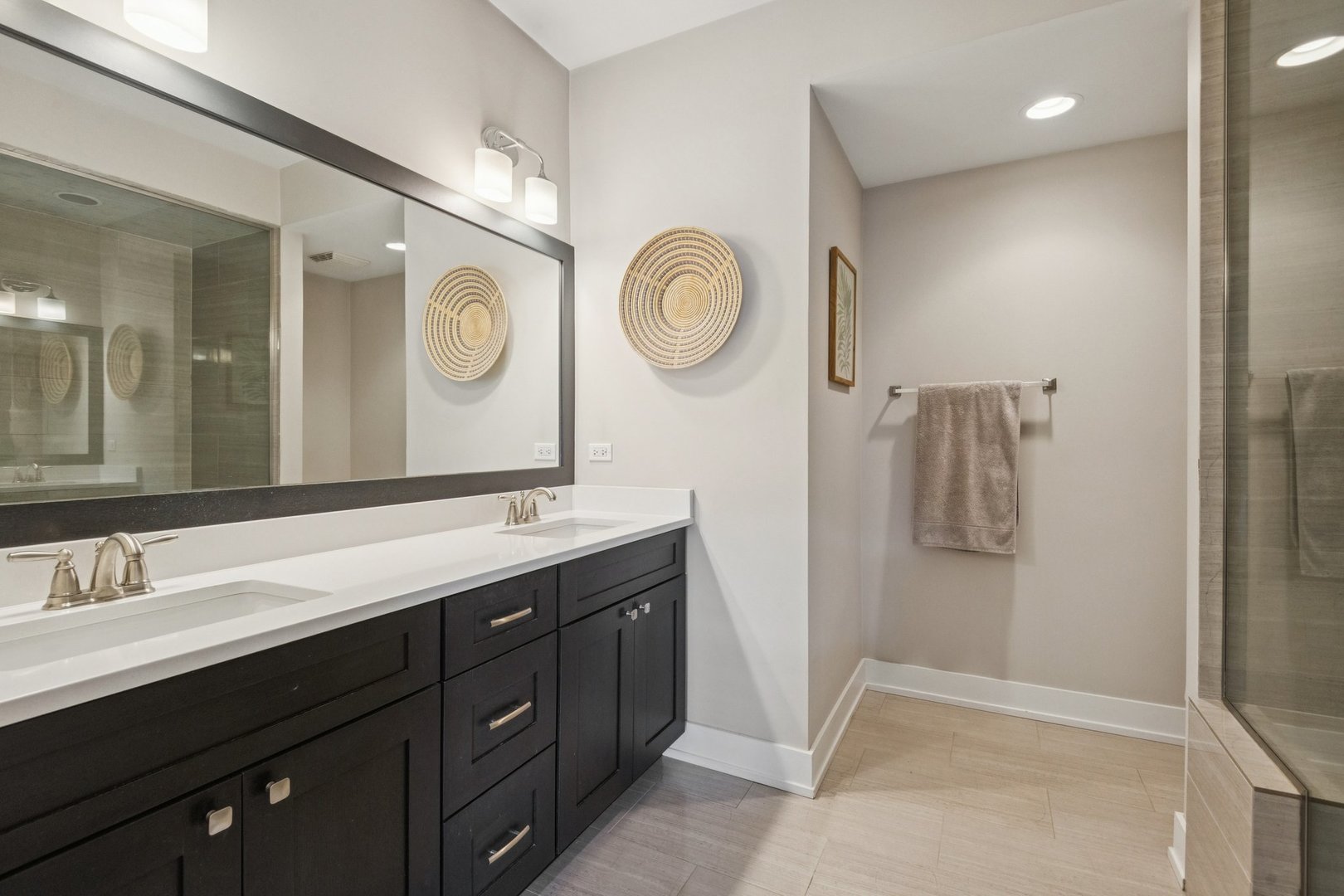 1011 North Wolcott Avenue, Unit 2N Chicago, IL 60622 - Photo 16 of 23 a bathroom with a double vanity sink and a mirror