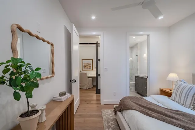 a bathroom with a granite countertop sink a toilet and shower