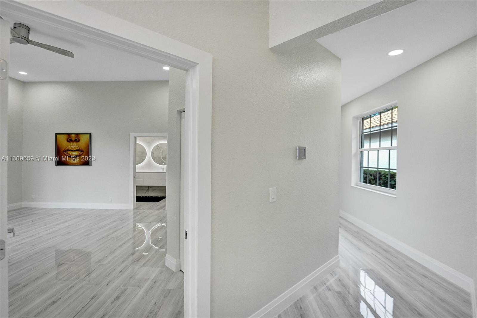 6688 Northwest 25th Court Boca Raton, FL 33496 - Photo 15 of 64 a view of an entryway with wooden floor