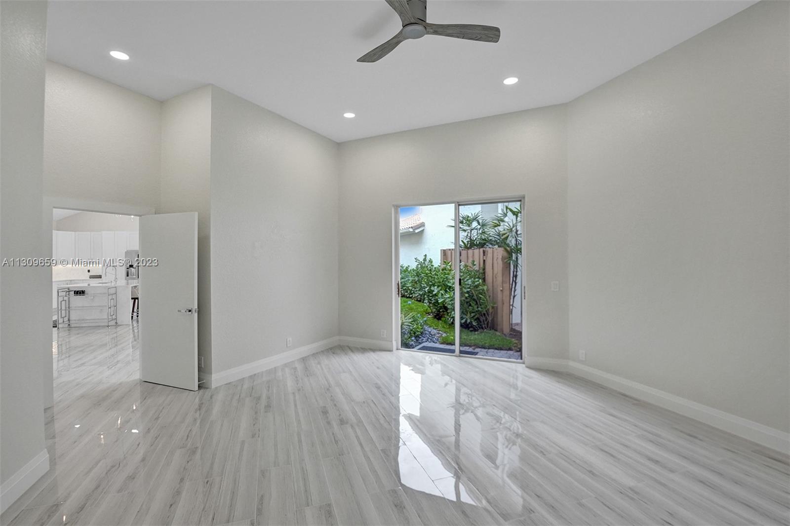 6688 Northwest 25th Court Boca Raton, FL 33496 - Photo 17 of 64 wooden floor in an empty room with a window