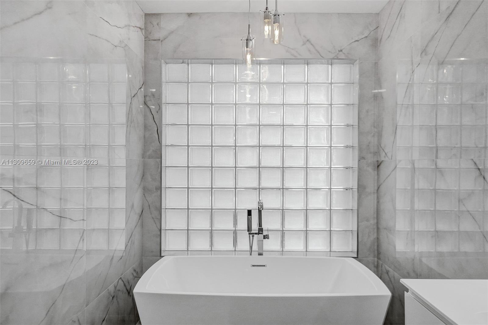 6688 Northwest 25th Court Boca Raton, FL 33496 - Photo 20 of 64 a bathroom with a bathtub and shower