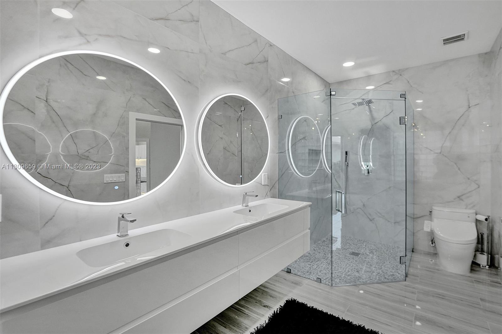 6688 Northwest 25th Court Boca Raton, FL 33496 - Photo 21 of 64 a bathroom with a double vanity sink and mirror
