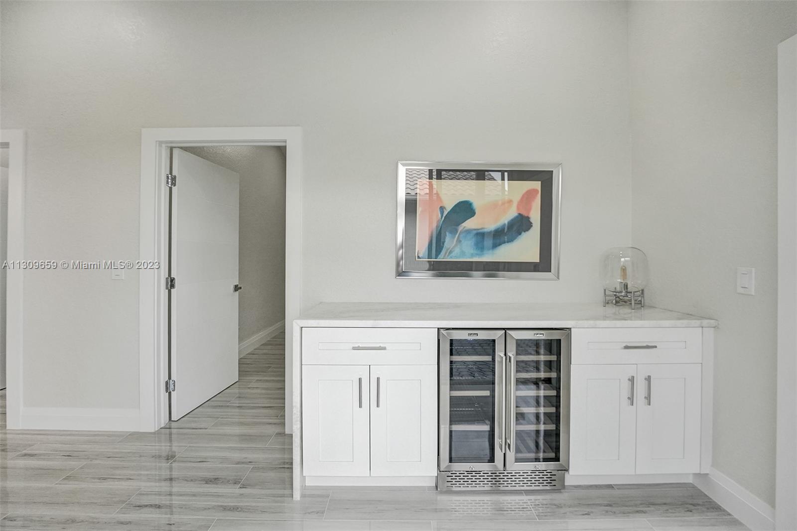 6688 Northwest 25th Court Boca Raton, FL 33496 - Photo 25 of 64 a view of a hallway with wooden floor and cabinet