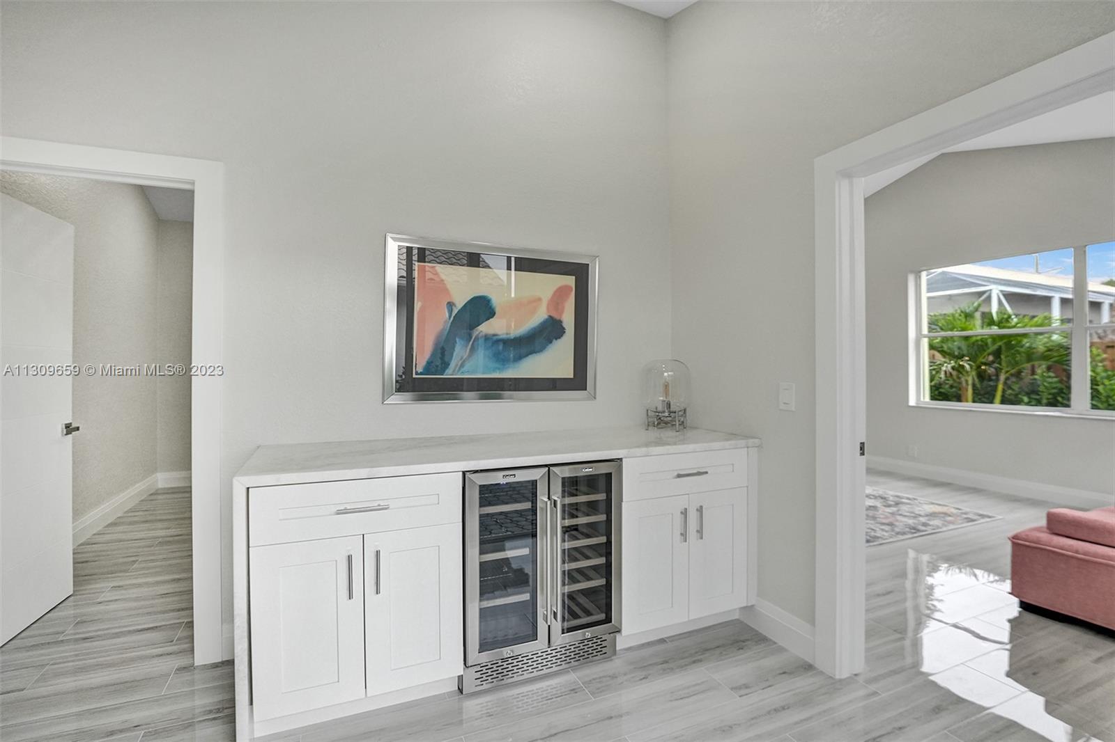 6688 Northwest 25th Court Boca Raton, FL 33496 - Photo 26 of 64 a view of a hallway with wooden floor and cabinet