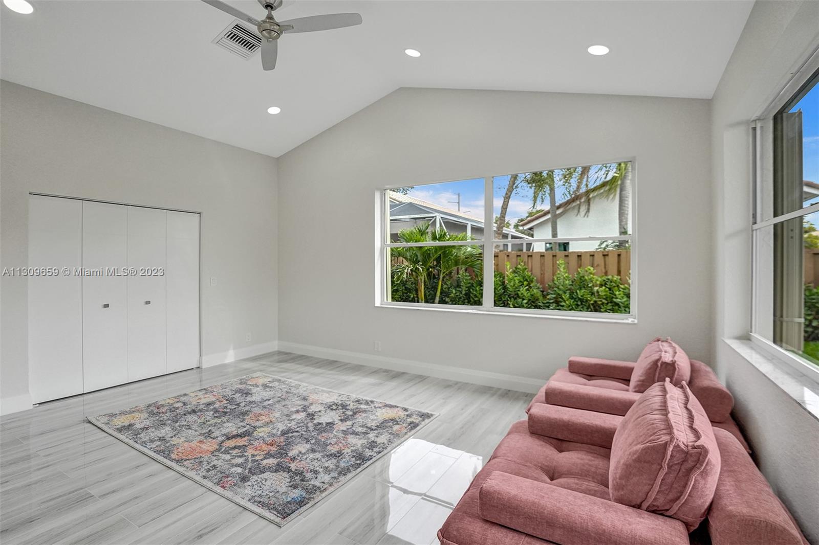 6688 Northwest 25th Court Boca Raton, FL 33496 - Photo 27 of 64 a living room with furniture and a rug