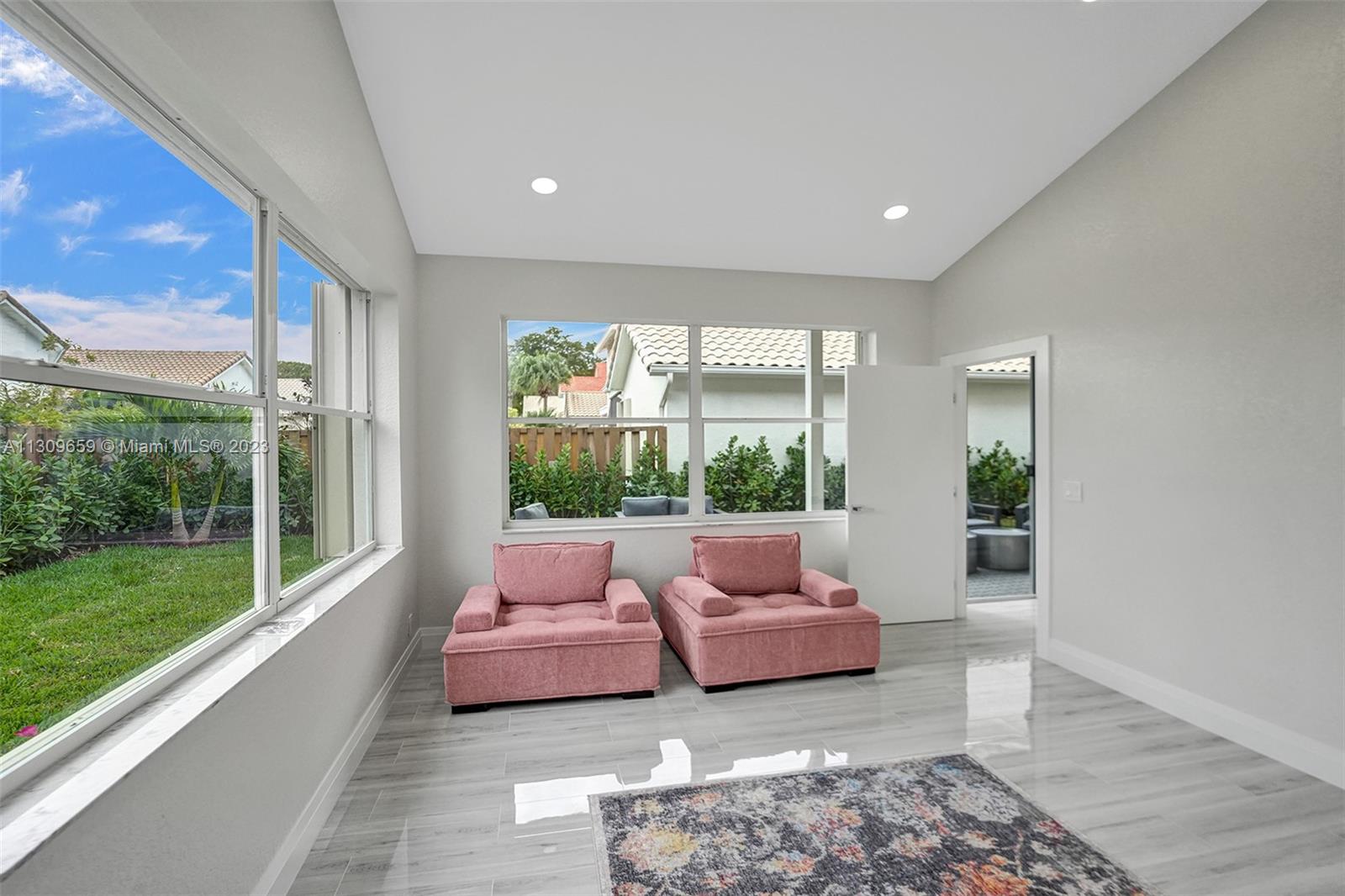 6688 Northwest 25th Court Boca Raton, FL 33496 - Photo 28 of 64 a living room with furniture and a yard