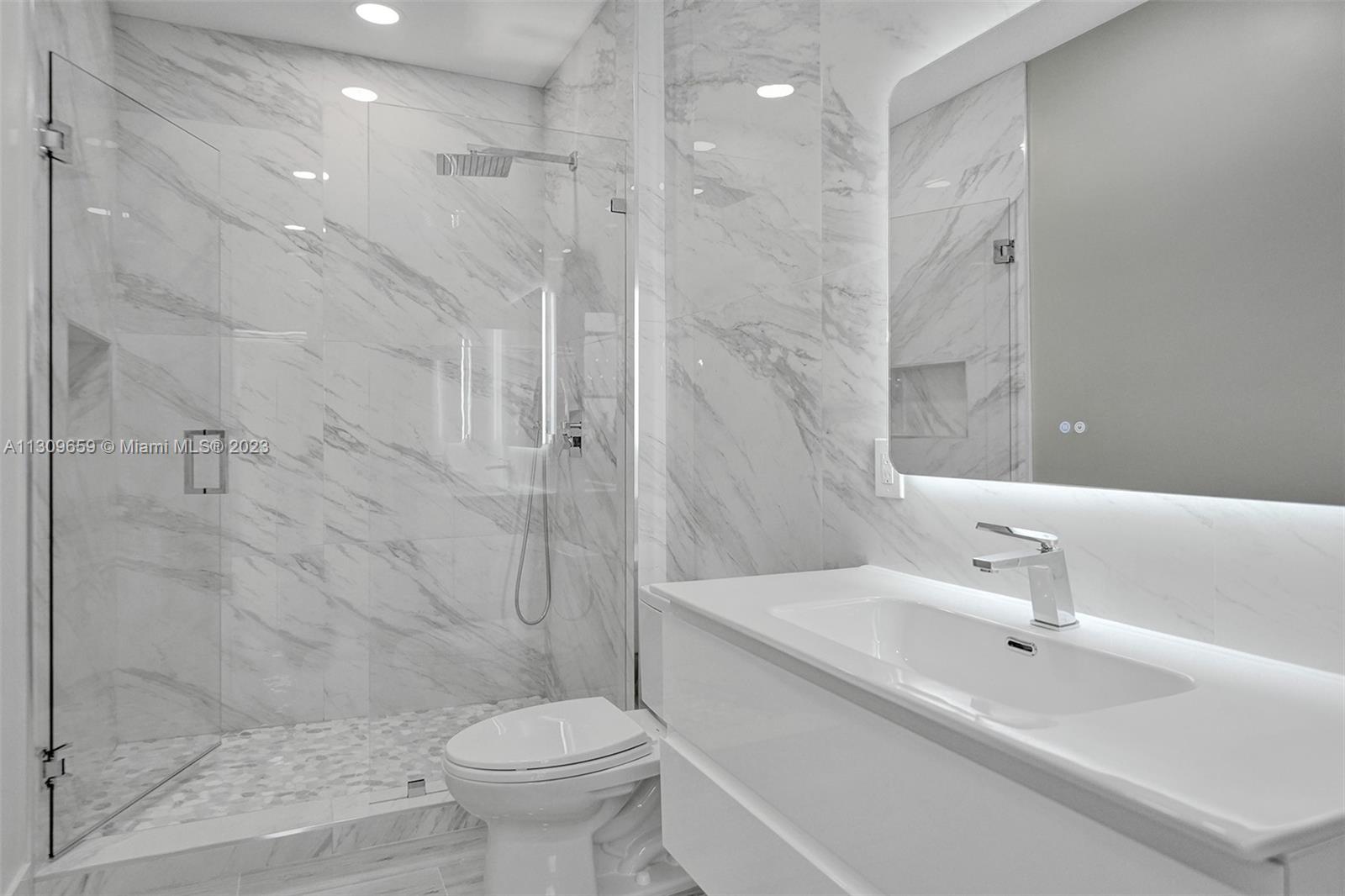 6688 Northwest 25th Court Boca Raton, FL 33496 - Photo 32 of 64 a bathroom with a sink toilet and shower