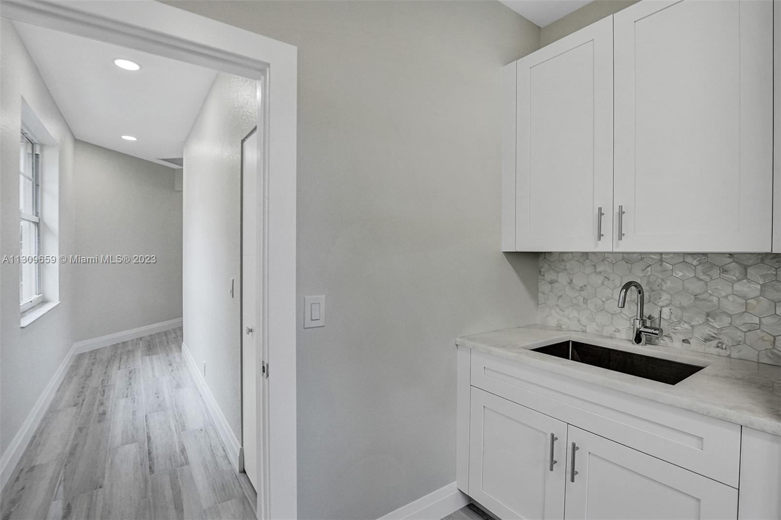 6688 Northwest 25th Court Boca Raton, FL 33496 - Photo 37 of 64 a bathroom with a sink and a mirror