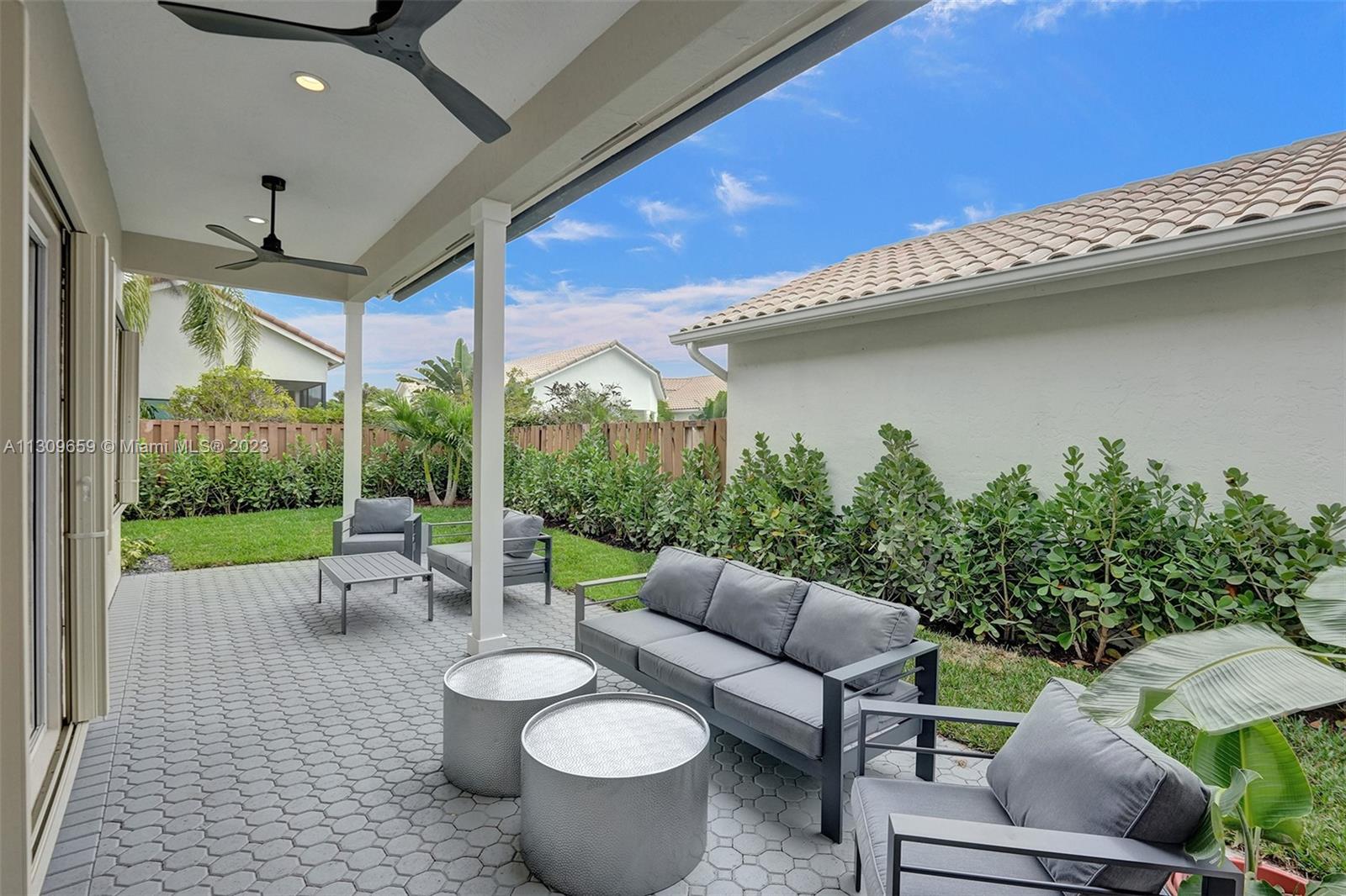 6688 Northwest 25th Court Boca Raton, FL 33496 - Photo 38 of 64 a outdoor living space with furniture and garden view