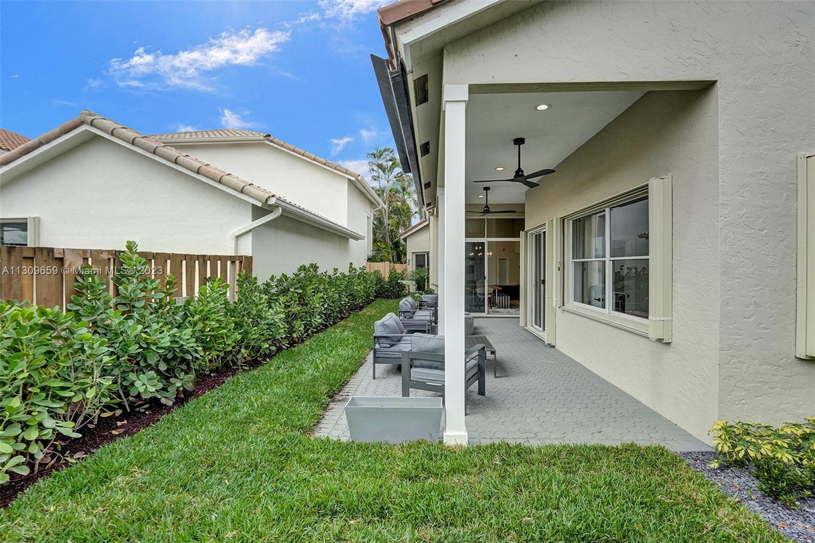 6688 Northwest 25th Court Boca Raton, FL 33496 - Photo 41 of 64 a view of a house with brick walls and a yard with plants