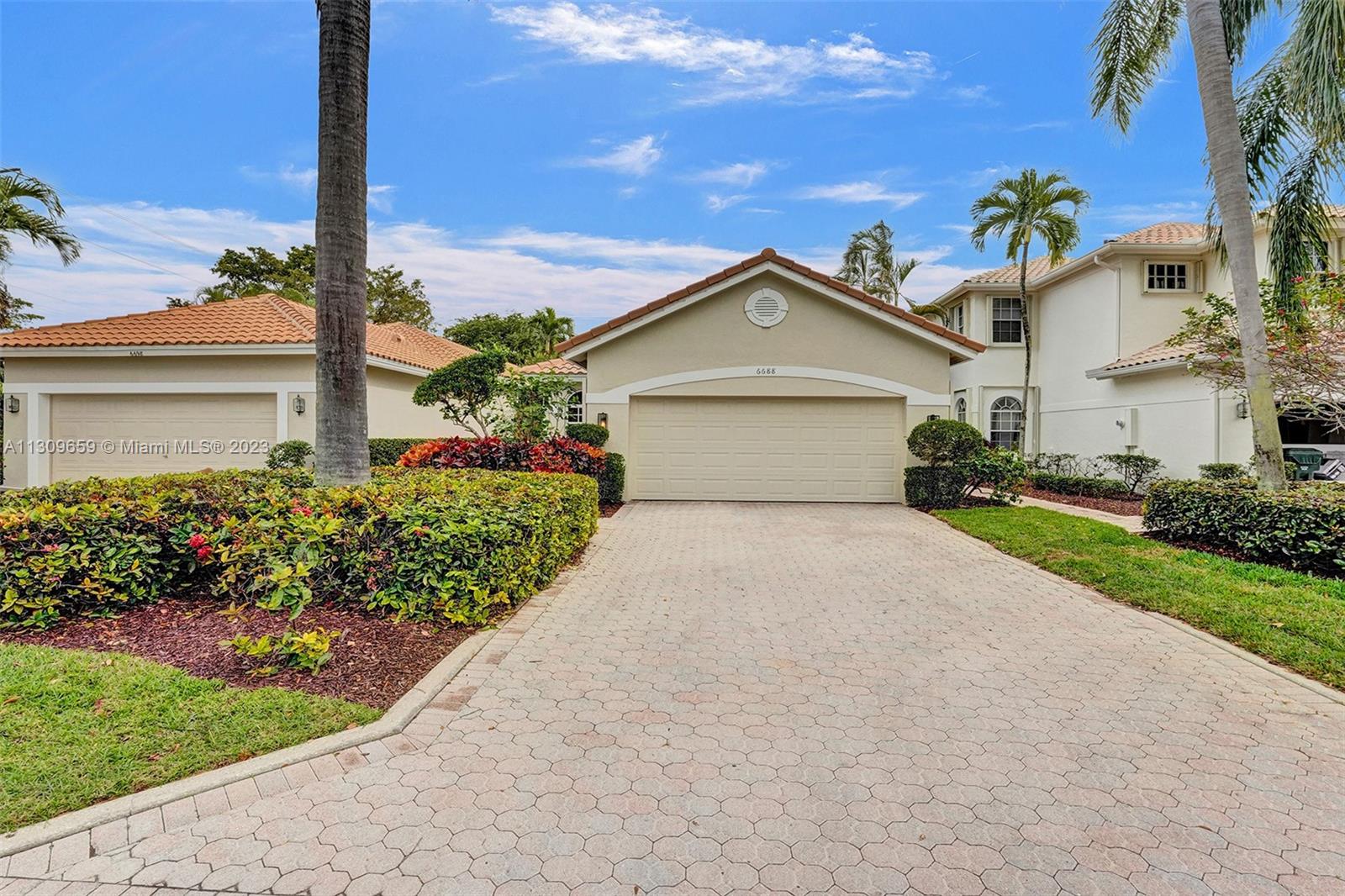6688 Northwest 25th Court Boca Raton, FL 33496 - Photo 44 of 64 a front view of a house with a yard