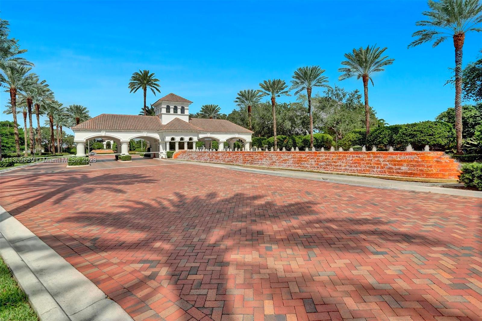 6688 Northwest 25th Court Boca Raton, FL 33496 - Photo 48 of 64 a front view of a house with a yard and garage
