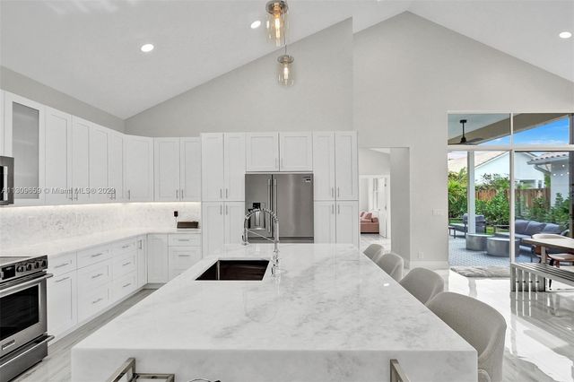a kitchen with granite countertop a stove and a sink