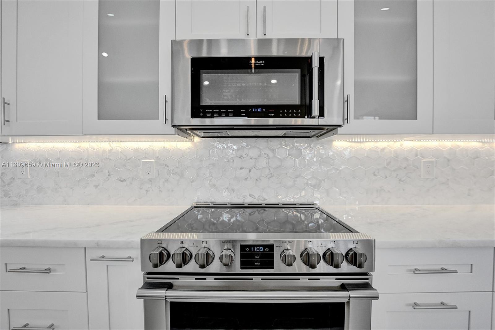 6688 Northwest 25th Court Boca Raton, FL 33496 - Photo 8 of 64 a stove top oven sitting inside of a kitchen