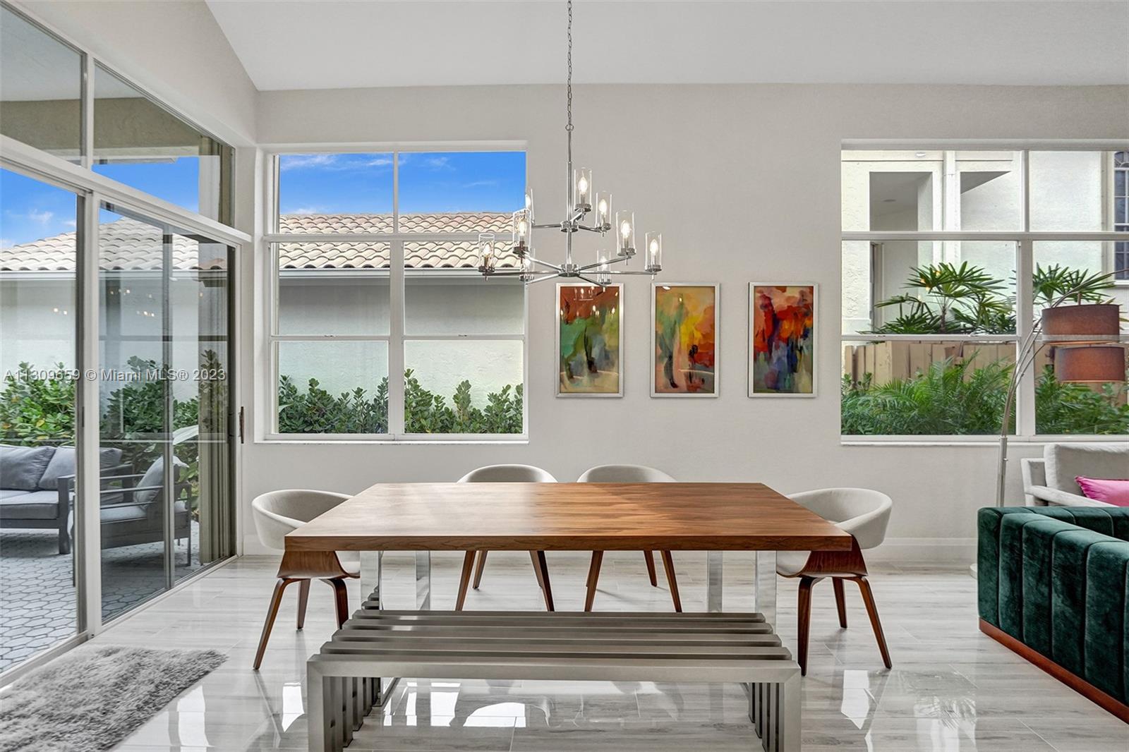 6688 Northwest 25th Court Boca Raton, FL 33496 - Photo 10 of 64 a view of a dining room with furniture window and outside view