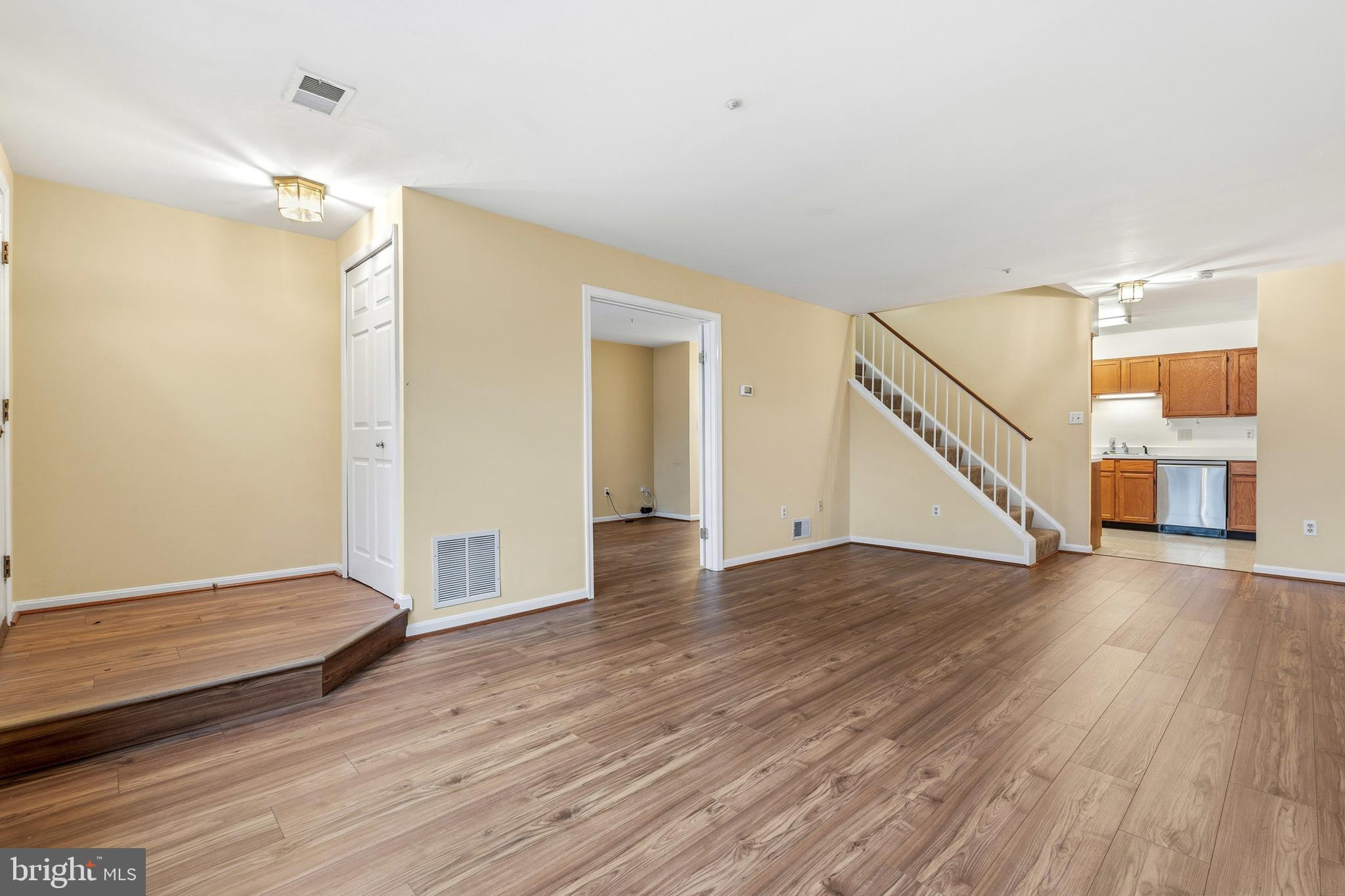 2 Highstream Court, Unit 684 Germantown, MD 20874 - Photo 15 of 25 a view of empty room with wooden floor and stairs