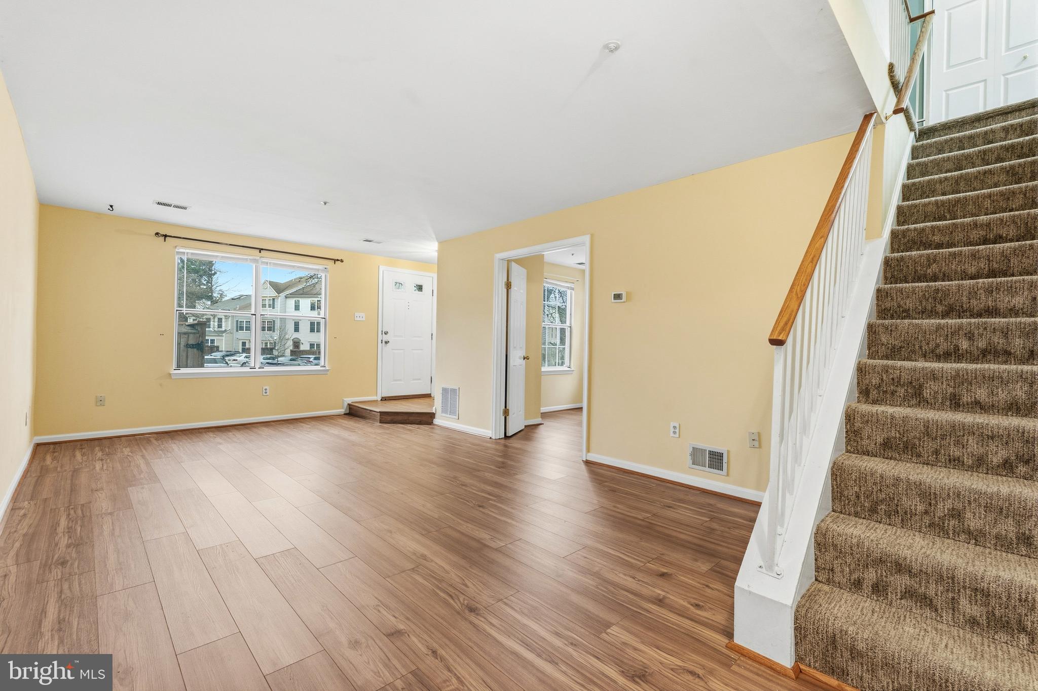 2 Highstream Court, Unit 684 Germantown, MD 20874 - Photo 16 of 25 a view of an empty room with wooden floor and stairs