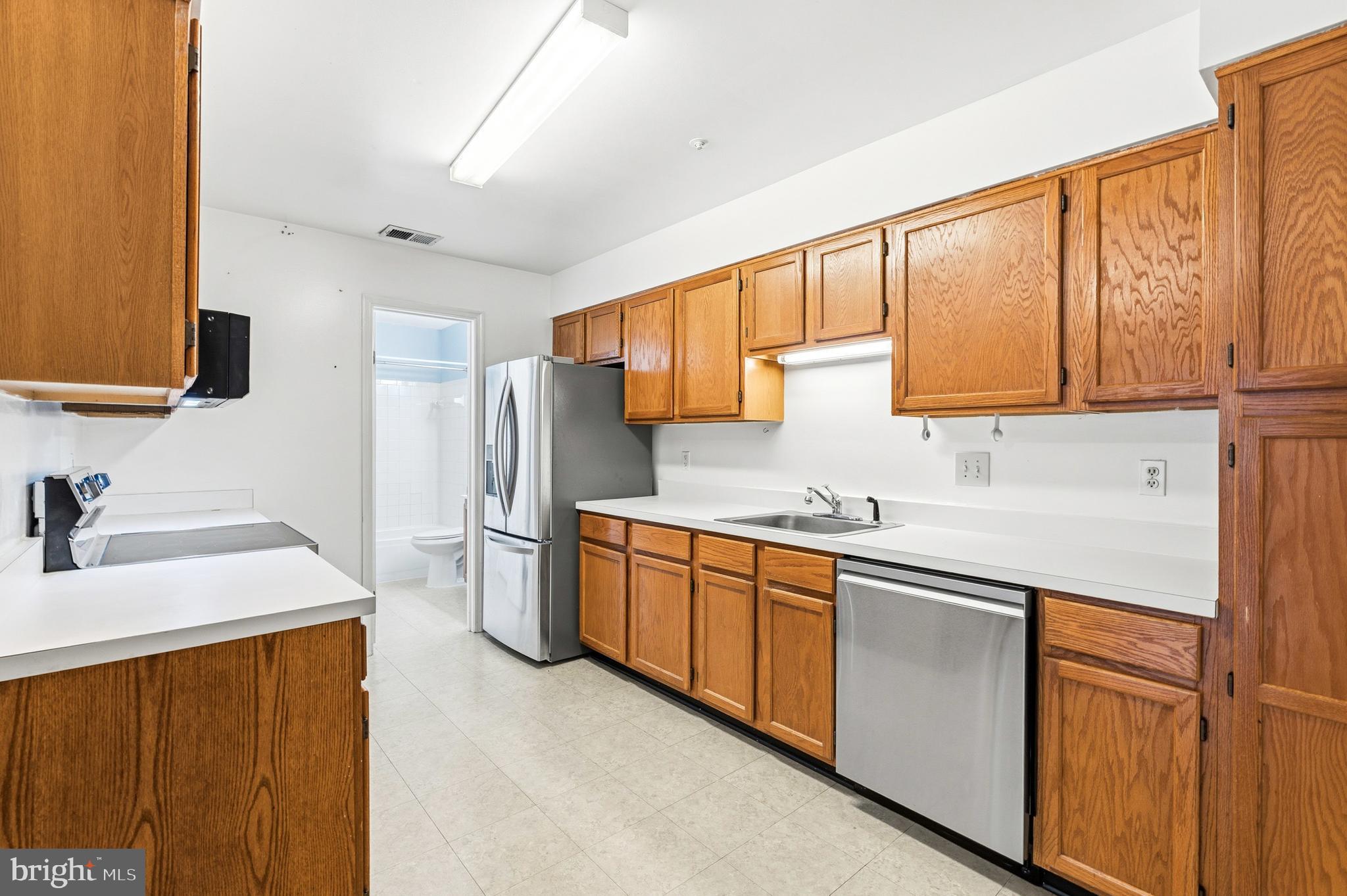 2 Highstream Court, Unit 684 Germantown, MD 20874 - Photo 3 of 25 a kitchen with stainless steel appliances granite countertop a sink stove and refrigerator