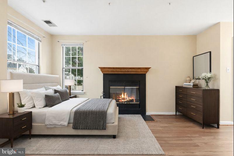 2 Highstream Court, Unit 684 Germantown, MD 20874 - Photo 5 of 25 a spacious bedroom with a bed and a mirror on dresser
