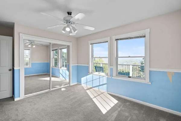 a view of a balcony with two chairs and a deck