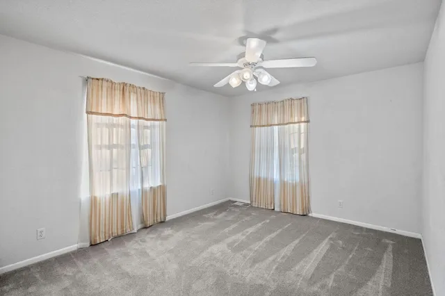 a view of a patio with table and chairs potted plants