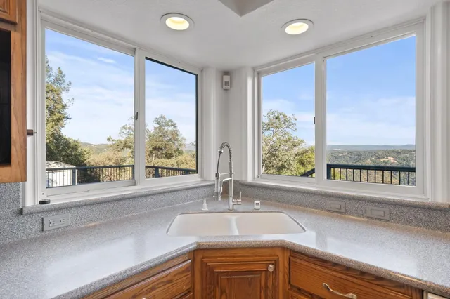 a kitchen with a sink and large window