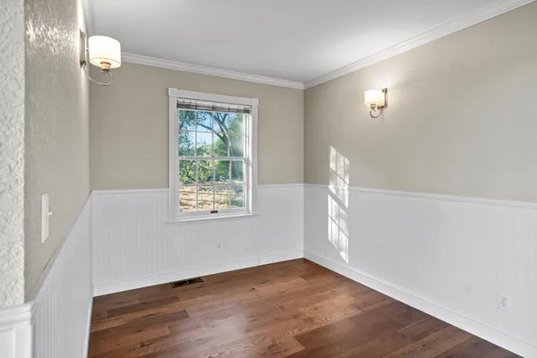 a view of a house with wooden deck front of house