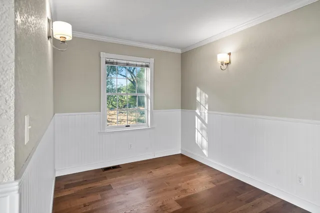 a view of a house with wooden deck front of house