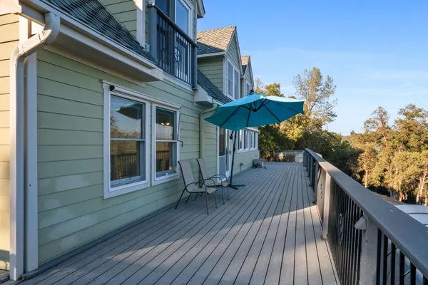 a balcony with wooden floor and city view