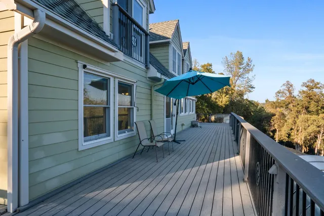 a balcony with wooden floor and city view