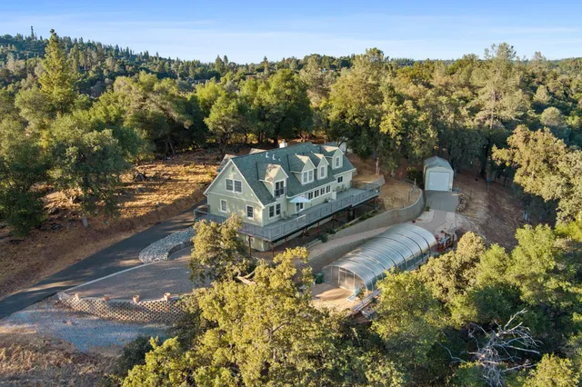 a aerial view of a house with a yard and sitting area