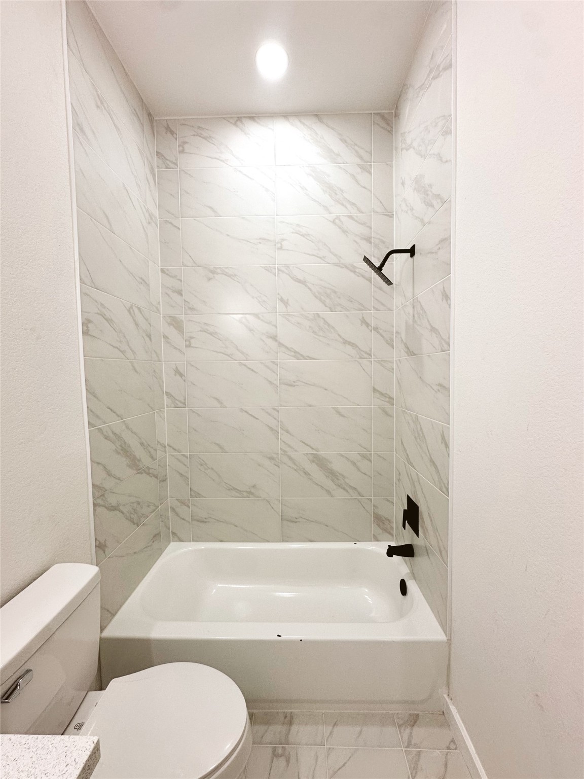 9713 Cargill Street Houston, TX 77029 - Photo 13 of 23 a bathroom with a toilet and a bath tub