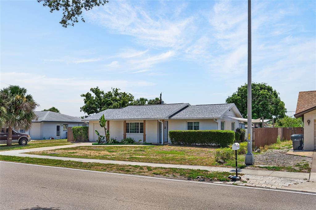 532 Center Road Venice, FL 34285 - Photo 10 of 68 a front view of a house with a garden